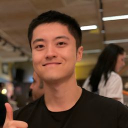 Jason Wang smiling and giving a thumbs-up